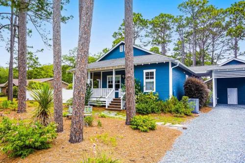 a blue house with trees in front of it at The Southport Cottage! in Southport