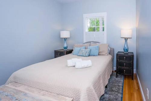 a bedroom with a large white bed with two night stands at The Southport Cottage! in Southport