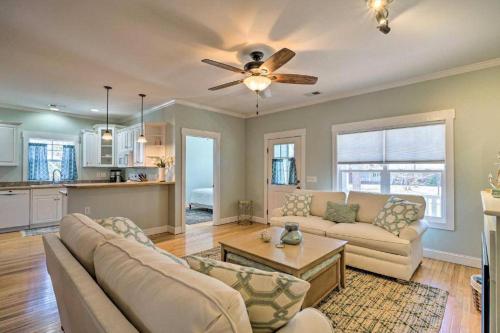 a living room with a couch and a ceiling fan at The Southport Cottage! in Southport