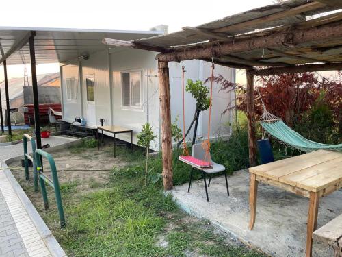 a patio with a hammock and a house at Mahane in Tirana