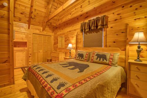 a bedroom with a bed in a log cabin at Buddy Bear #249 in Pigeon Forge