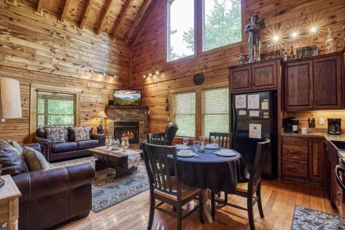 a dining room and living room with a table in a cabin at Camelot #266 in Pigeon Forge