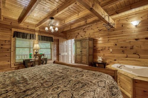 a bedroom with a bed and a tub in a room at Camelot #266 in Pigeon Forge