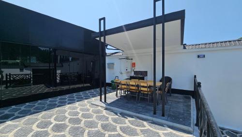 a room with a wooden table on a balcony at Luxury Milan Mountain Ponoramic Villa, indoor heated pool and jacuzzi with mountain view in Gabala