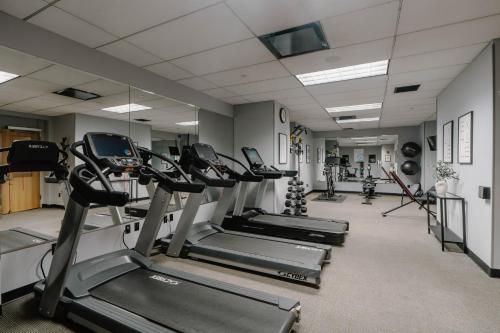a gym with several tread machines in a row at Club Quarters Hotel World Trade Center, New York in New York
