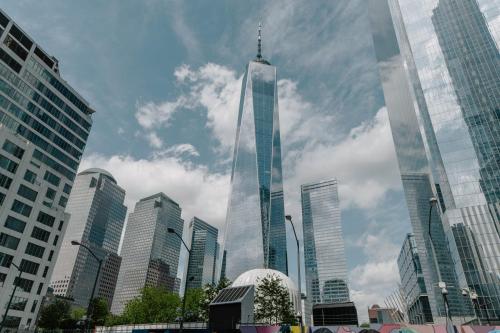 a tall skyscraper in the middle of a city at Club Quarters Hotel World Trade Center, New York in New York