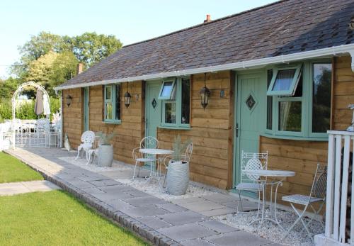 a house with chairs and tables on a patio at The Willowford in Milton Keynes