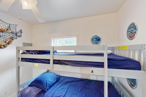 a white bunk bed in a white room at Bea's Fish Camp In The Pass in Pass Christian