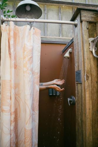 a person in a hammock in a shower at Costanoa in Pescadero