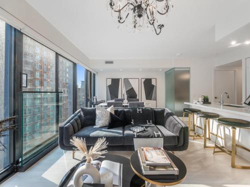 a living room with a couch and a table at Hazelton Suites - Yorkville - Indoor Pool & Hot Tub in Toronto