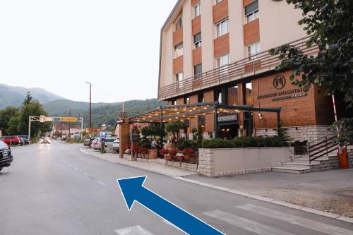 an arrow pointing to a building on a city street at Tara Apartments in Kolašin
