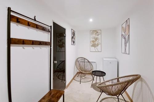 a white room with two chairs and a table at les piafs du der 1 in Joncreuil
