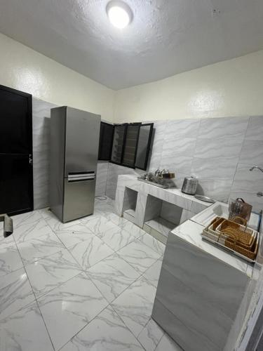 a kitchen with a refrigerator and a sink at Mamy Residence in Nouakchott