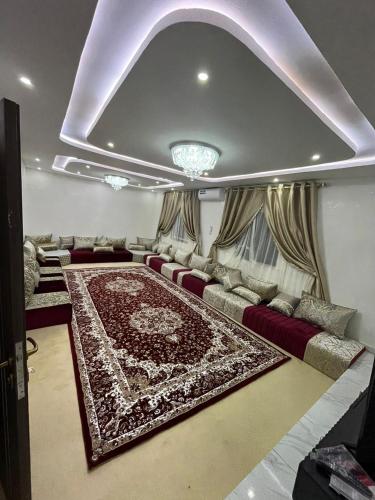 a living room with a couch and a rug at Mamy Residence in Nouakchott