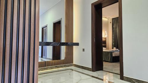 a hallway with a mirror and a room with a bed at Luxury Milan Mountain Ponoramic Villa, indoor heated pool and jacuzzi with mountain view in Gabala