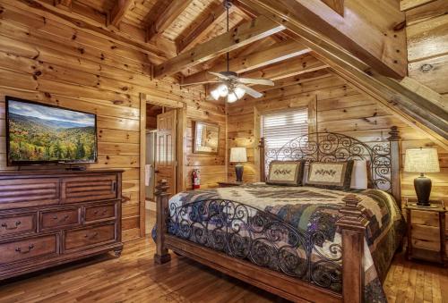 a bedroom with a bed and a flat screen tv at Farmers Retreat #221 in Sevierville