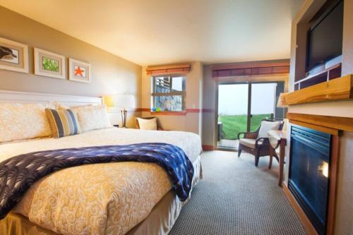 a hotel room with a bed and a television at The Ocean Lodge in Cannon Beach