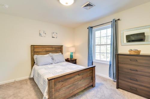 a bedroom with a bed and a dresser and a window at 3 Mi to Kalahari Pocono Summit Home with Pool Table in Pocono Summit