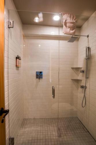 a shower with a glass door in a bathroom at The Ocean Lodge in Cannon Beach