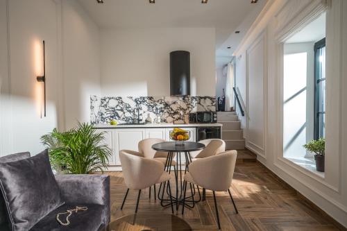 a kitchen and living room with a table and chairs at Montre Fine Living in Agios Nikolaos
