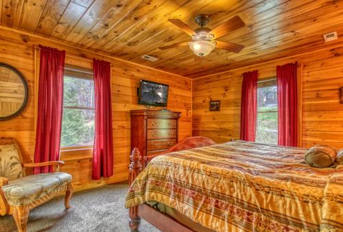 a bedroom with a bed and a ceiling fan at Gone Swimmin' #260 in Pigeon Forge