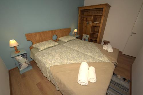 a bedroom with a large bed with towels on it at Petrasdream Lefkada in Lefkada