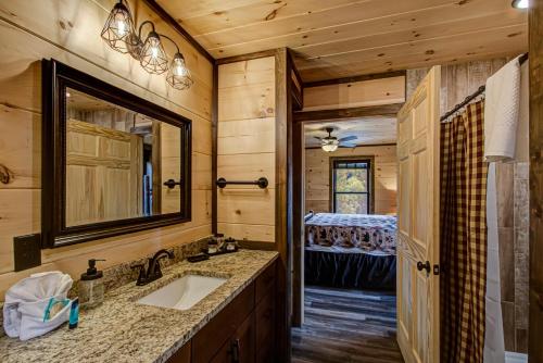a bathroom with a sink and a mirror at Honey Bear Hill #326 in Sevierville