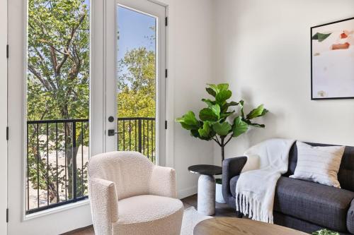 a living room with a couch and chairs and a window at The Corbin 1305 - The Columbia in Fort Worth