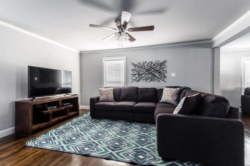 a living room with a couch and a flat screen tv at Winnetka Heights Hideaway in Dallas