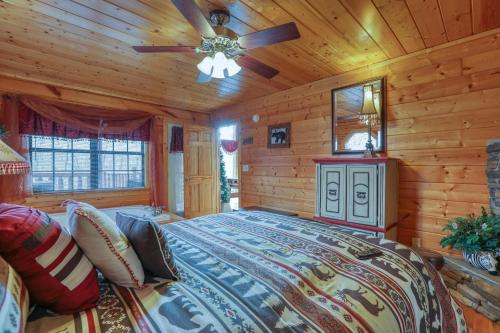 a bedroom with a bed and a ceiling fan at Kissing Retreat #269 in Sevierville