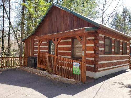 a log cabin with a fence in front of it at Leather And Lace #1615 in Gatlinburg
