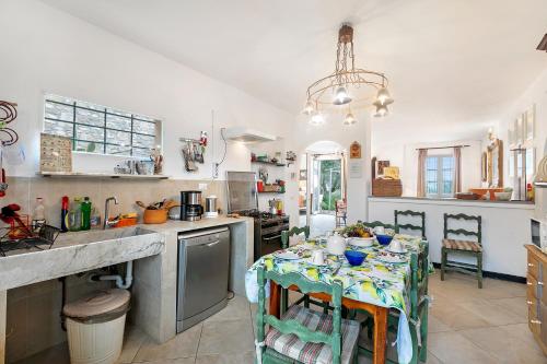 a kitchen with a table with a table cloth on it at Ca D'artista For Nature Lovers - Happy Rentals in Stellanello