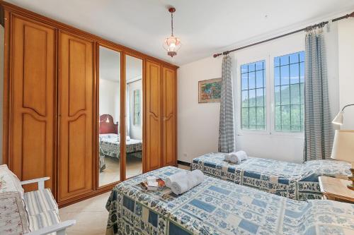 a bedroom with two beds and a mirror at Ca D'artista For Nature Lovers - Happy Rentals in Stellanello