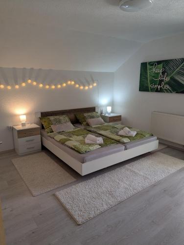 a bedroom with a large bed and two night stands at Ferienwohnung Luna mit Pool in Brinje
