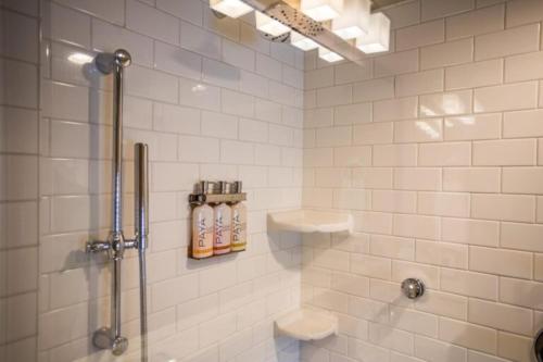 a bathroom with a shower and two shampoo bottles at The Ocean Lodge in Cannon Beach