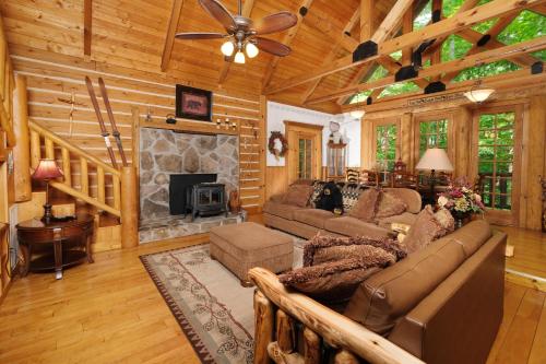 a living room with a couch and a fireplace at Park Paradise #254 in Sevierville