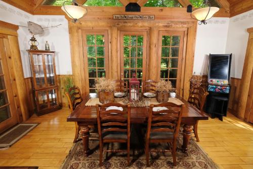 a dining room with a wooden table and chairs at Park Paradise #254 in Sevierville