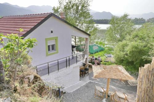 an aerial view of a house with a table and chairs at Apartman Skadarsko jezero bay in Vranjina