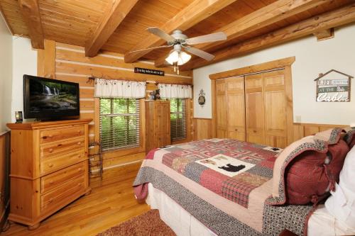 a bedroom with a bed and a ceiling fan at Park Paradise #254 in Sevierville