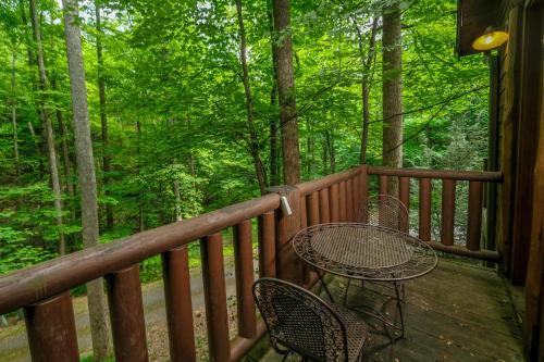 a wooden deck with a table and chairs on it at Park Paradise #254 in Sevierville
