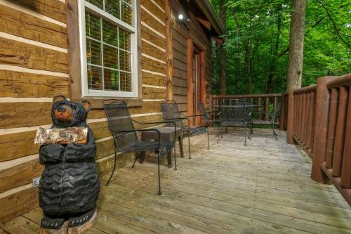a porch of a cabin with a bear statue on it at Park Paradise #254 in Sevierville