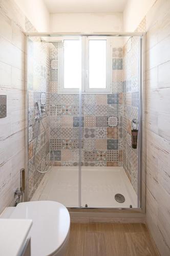 a bathroom with a shower with a toilet and a sink at La Raganella D'Oro in Pico