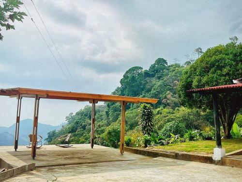 a wooden pavilion with a view of a mountain at Habitacion en increible ecolodge en Vista Nieves -- in Minca