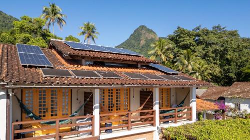 a house with solar panels on the roof at Pousada Rubi in Abraão