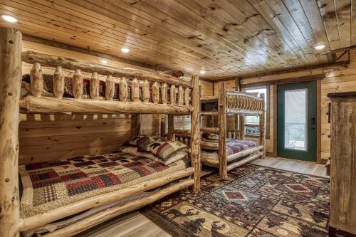 a bedroom with bunk beds in a log cabin at Pooling Around #200 in Gatlinburg