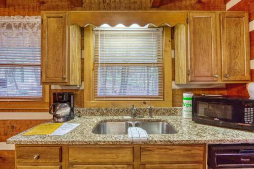 a kitchen with a sink and a microwave at Puppy Love #1619 in Gatlinburg