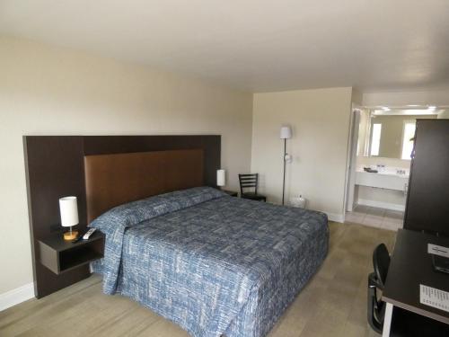 a hotel room with a bed and a television at Gators Inn on the Bayou in Larose
