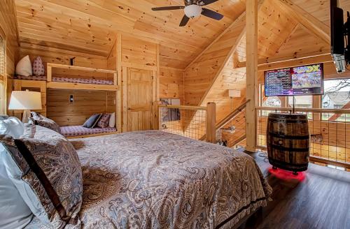 a bedroom with a bed in a wooden cabin at River Elegance #2335 in Pigeon Forge