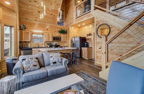 a living room and kitchen in a log cabin at River Elegance #2335 in Pigeon Forge