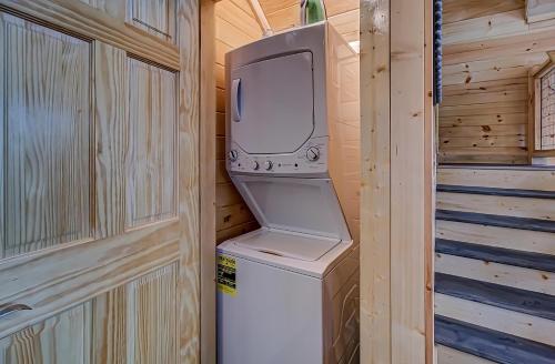 a television sitting on top of a washer and dryer at River Elegance #2335 in Pigeon Forge